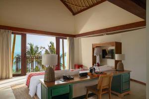 圣吉吉Kalandara Resort Lombok的一间卧室配有一张桌子和一张美景床。