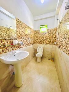 卡图纳耶克Touch Down Family Restaurant & hotel的一间带水槽和卫生间的浴室