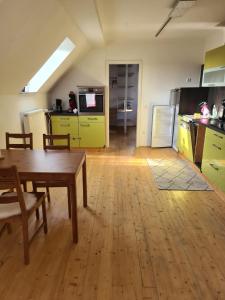 FrohburgBrick House的厨房配有木桌和黄色橱柜。