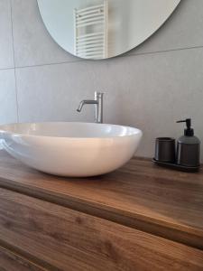 米兰Massi’s House的浴室内木制柜台上的白色水槽