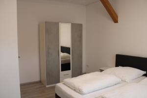 CaldenGrand Apartments Kassel的卧室配有镜子,位于床边