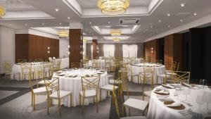 比亚韦斯托克Apartamenty Branicka的宴会厅配有白色桌子和金色椅子