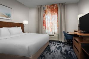 巴拿马城海滩Fairfield Inn & Suites by Marriott Panama City Beach的酒店客房配有一张床、一张书桌和一台电视。