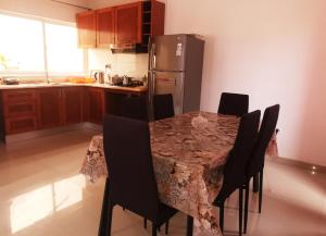 普拉亚Miras Guest House的厨房配有桌椅和冰箱。