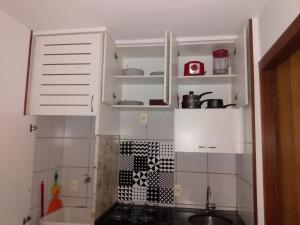 巴西利亚Sudoeste H215的厨房配有白色橱柜和水槽