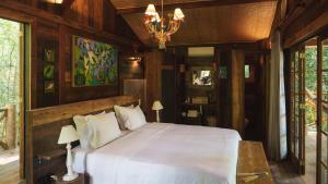 伊泰帕瓦坦卡玛拿旅馆的一间卧室配有一张床和一个吊灯