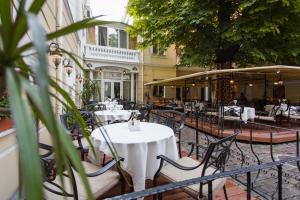 敖德萨Residence Odesskij Dvorik的室外餐厅设有桌椅和遮阳伞。