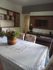 南卡希亚斯Apto central completo com garagem的一张桌子,上面有白色的桌布和植物