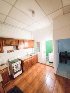 拉乌尼翁Acogedora casa en Lomas de Bella Vista的厨房配有木制橱柜和炉灶烤箱。