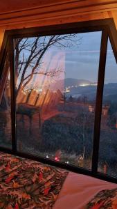 萨潘贾HappyHouse Bungalov Three-Room, SPA pleasure with lake view, Sapanca B1的卧室的窗户,享有树景