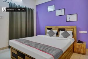 辛加瓦迪Townhouse Imperial Inn Hinjewadi的一间卧室设有一张紫色墙壁的大床
