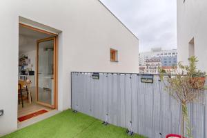奥贝维利埃Résidor - Lumineux appartement的白色的房子,设有绿草阳台