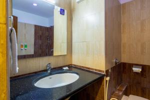 班加罗尔Blue Bliss Hotel By PPH Living的一间带水槽和镜子的浴室