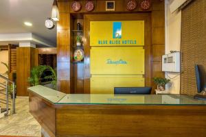 班加罗尔Blue Bliss Hotel By PPH Living的大堂黄色墙上的蓝色粉尘球标