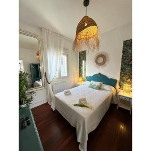 维戈La Nueva Casa del Barco del Humo的卧室配有一张白色大床和吊灯。