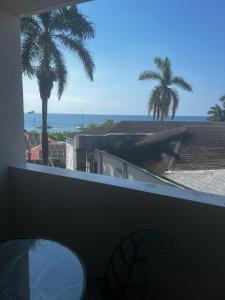 蒙特哥贝Sunny Tides at Montego Bay Club Resort的阳台享有海景,种植了棕榈树。