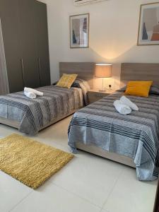 梅利哈Ta'lonza Luxury Near Goldenbay With Hot Tub App1的卧室内两张并排的床