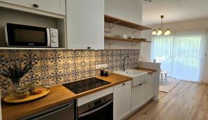 绍莱Appartement Le Porto的厨房配有水槽和微波炉