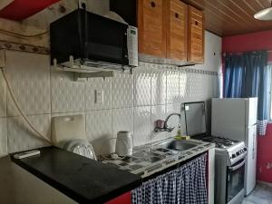 特立尼达岛Casita céntrica的一间带水槽和微波炉的小厨房