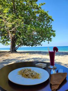 MaujawaKANDORA Luxury villas的海滩上桌子上放着一盘面食