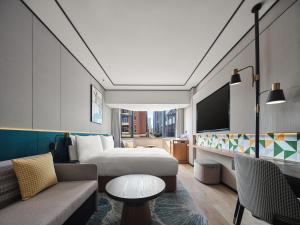 杭州杭州西湖希尔顿花园酒店的酒店客房,配有床和沙发