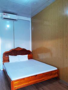 Rạch TàuHomestay Nguyễn Hùng的一间卧室配有一张带白色床单的木床