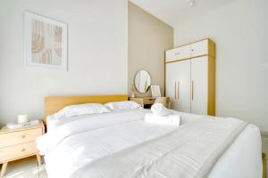 怡保The Horizon Ipoh的白色卧室设有一张大床和镜子
