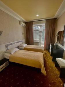 特鲁斯卡韦茨VitaPark Stariy Dub的酒店客房设有三张床和窗户。