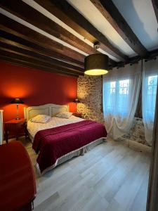 谢夫勒斯谢夫勒斯度假屋的一间红色墙壁的卧室和一张红色床单