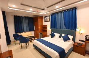新德里Hotel Down Town Paschim Vihar的配有一张床和一张书桌的酒店客房