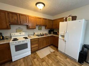 Mount GayRuby’s Retreat的厨房配有白色冰箱和木制橱柜。