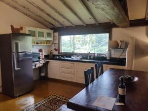 蒂拉登特斯Casa Moitará的厨房配有不锈钢冰箱和桌子
