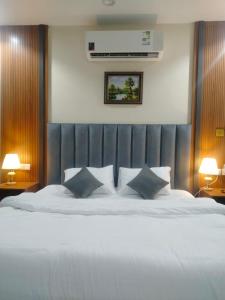 麦地那فندق انسام طيبة للضيافة的卧室配有一张带两个枕头的大白色床