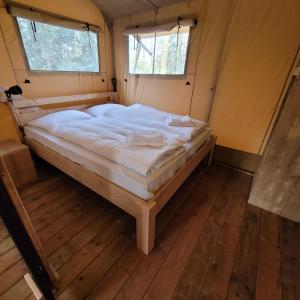 雷讷瑟Heated & brand new Forestlodge的一张大床,位于带两个窗户的房间