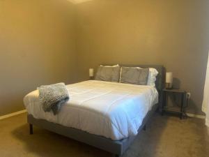 凤凰城Cozy Condo in Gated Community with Pool by PHX Airport, Tempe, and Old Town的卧室配有一张带白色床单和枕头的大床。