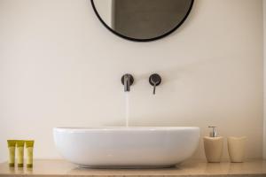 根纳迪Aethrion Villas & Suites的浴室设有白色水槽和镜子