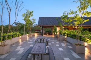 维勒珀图Thimbiri Wewa Resort Wilpattu的天井设有长椅和树木及灯光