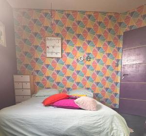 La Guerche-de-BretagneJolie maison avec piscine et Spa的一间卧室配有一张带彩色墙壁的床