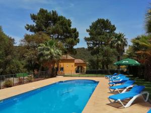 赫罗纳Villa Solimar的一个带躺椅和遮阳伞的游泳池