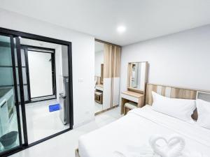 Ban Nong WaengS&Y Apartment的卧室配有白色的床和窗户。