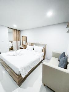 Ban Nong WaengS&Y Apartment的一间卧室配有一张大床和一张沙发