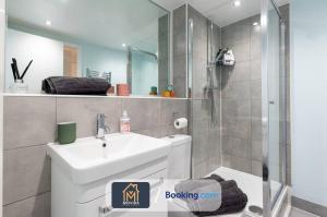 利兹Stylish Two Bed City Centre Apartment By Movida Property Group Short Lets & Serviced Accommodation Leeds的浴室配有白色水槽和淋浴。
