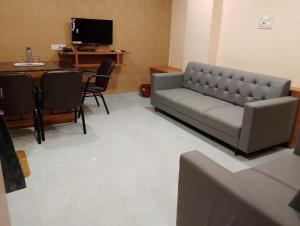 ShinayaHOTEL PARADISE INN的客厅配有沙发和桌子