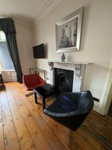 汤顿Taunton Town House的客厅配有椅子和壁炉