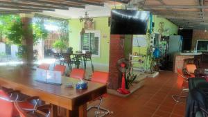 贡布Jasmine Resort Kampot的一间带桌椅和电视的用餐室