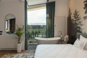 布朗Green Resort Bran的带浴缸、床和窗户的浴室