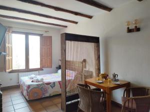 埃尔韦鲁埃科拉德埃萨阿罗雅蜜恩拖斯酒店的一间卧室配有一张床和一张桌子及椅子