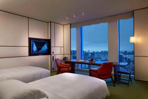 东京东京虎之门之丘安达仕酒店的酒店客房设有两张床和一张书桌,享有美景。