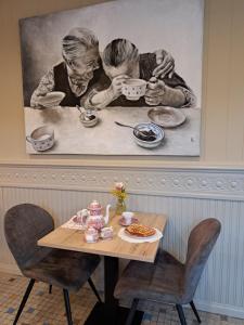 阿勒Au Coeur d'Alle的一张画,画着两个人在桌子边喝茶
