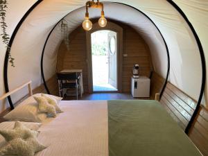 坎普朗莫道尼斯White Spring Glamping的帐篷内一间卧室,配有一张大床